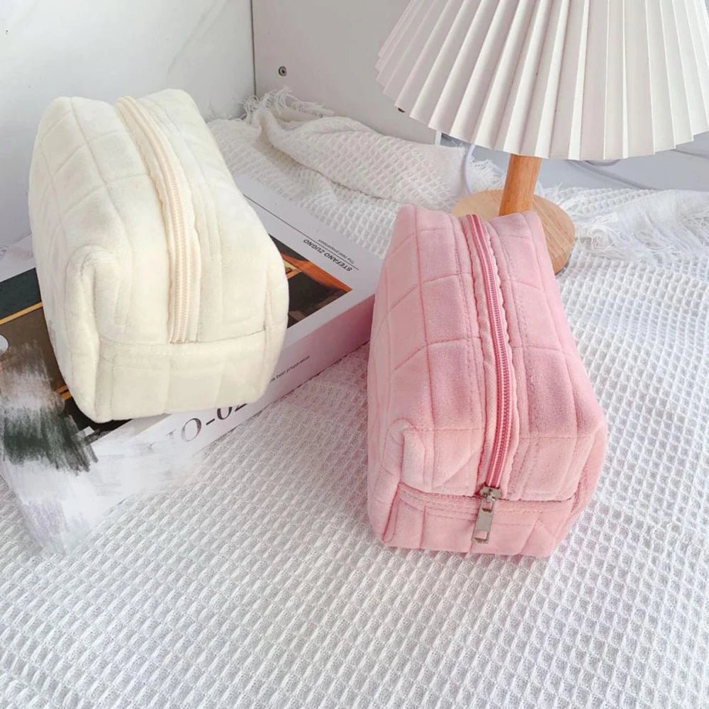 Soft pink plush cosmetic bag open showing interior compartments